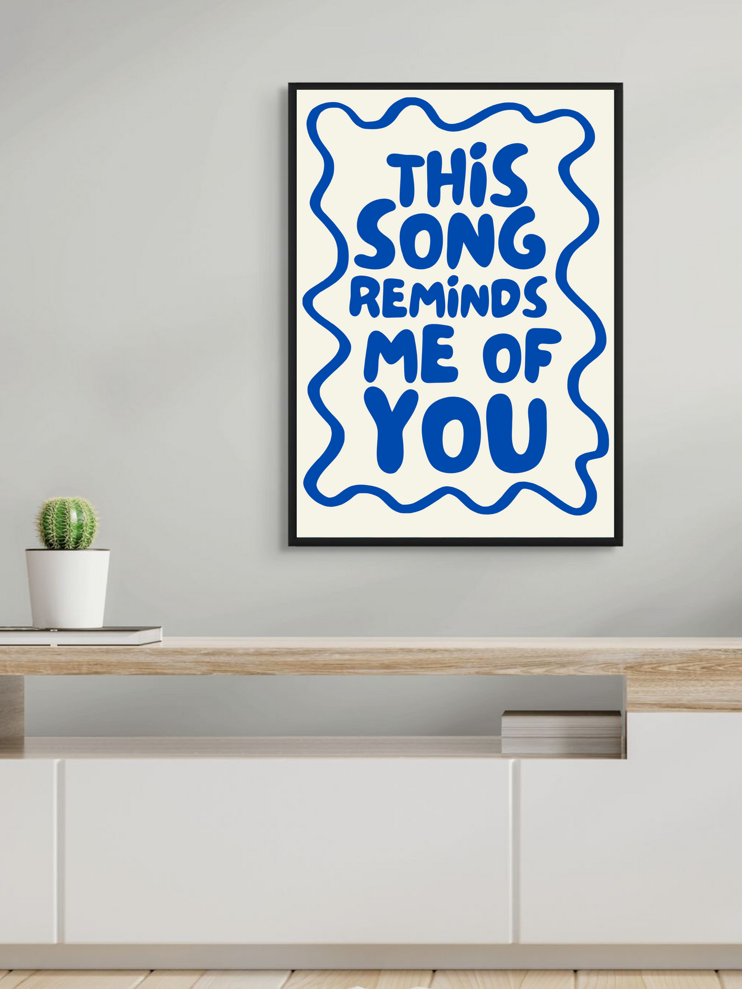Stylish wall art print featuring the phrase 'This song reminds me of you' in blue, ideal for modern home decor.