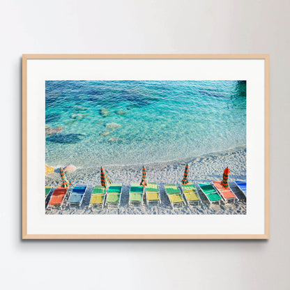 Empty beach with closed umbrellas on italian coast