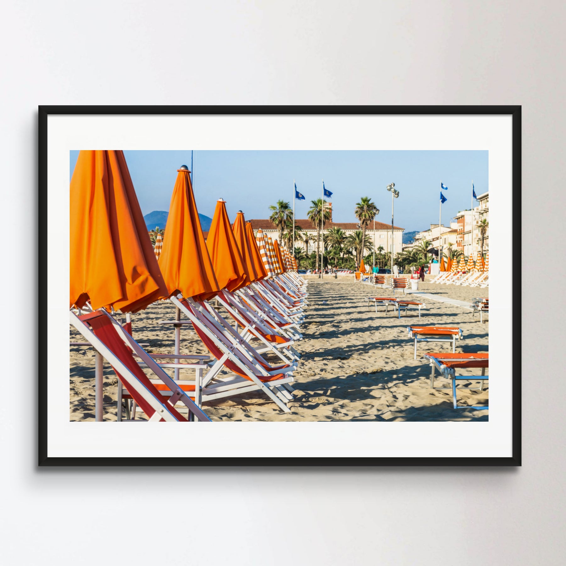 Viareggio beach with colorful umbrellas at sunset, Viareggio, Italy.