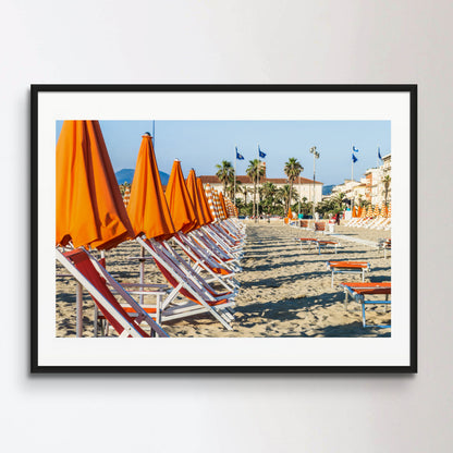 Viareggio beach with colorful umbrellas at sunset, Viareggio, Italy.