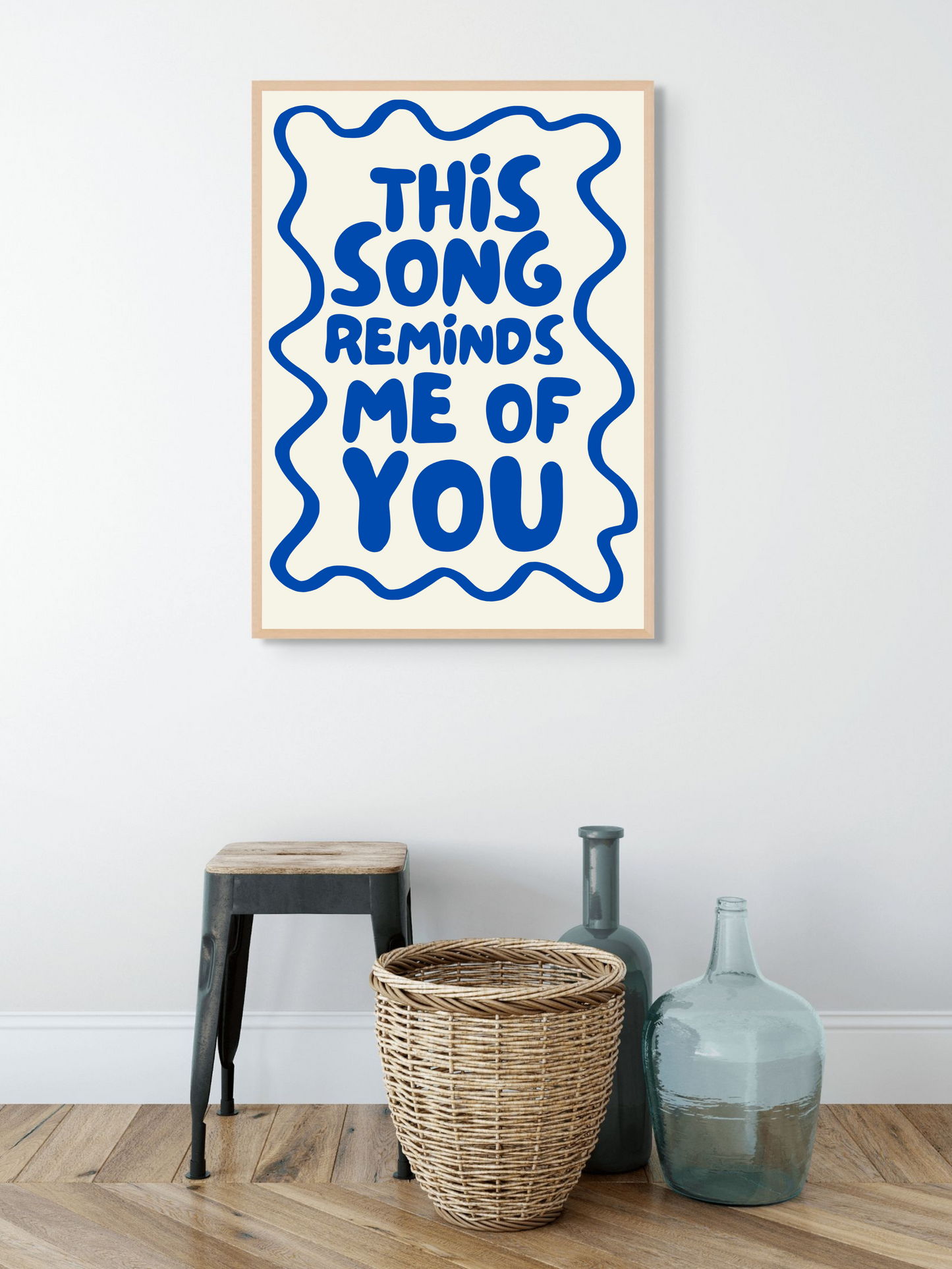 Aesthetic wall art print featuring the phrase 'This song reminds me of you' in blue on a stylish backdrop.