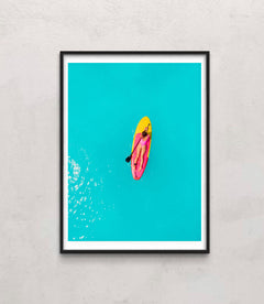 Beautiful woman on stand up paddle board in blue ocean