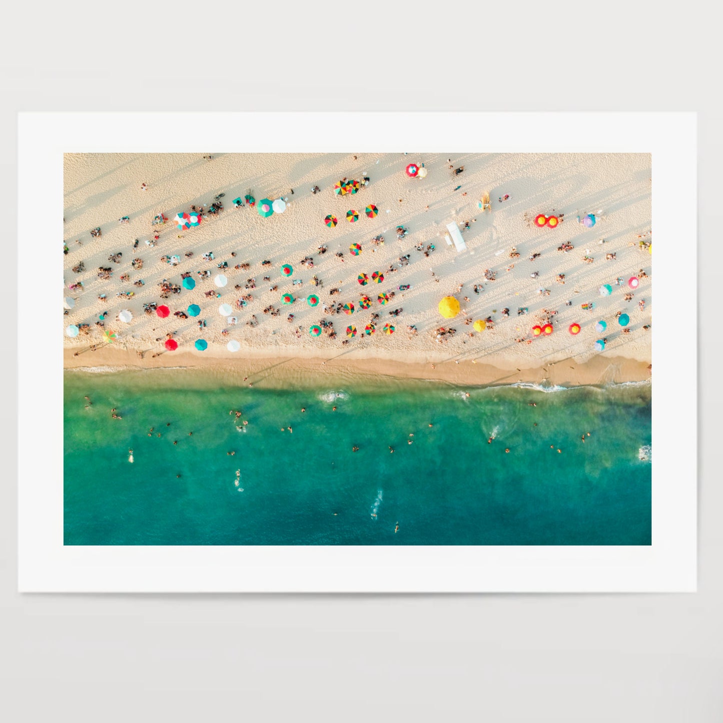 Aerial view of a crowded beach, umbrellas and people on the sand