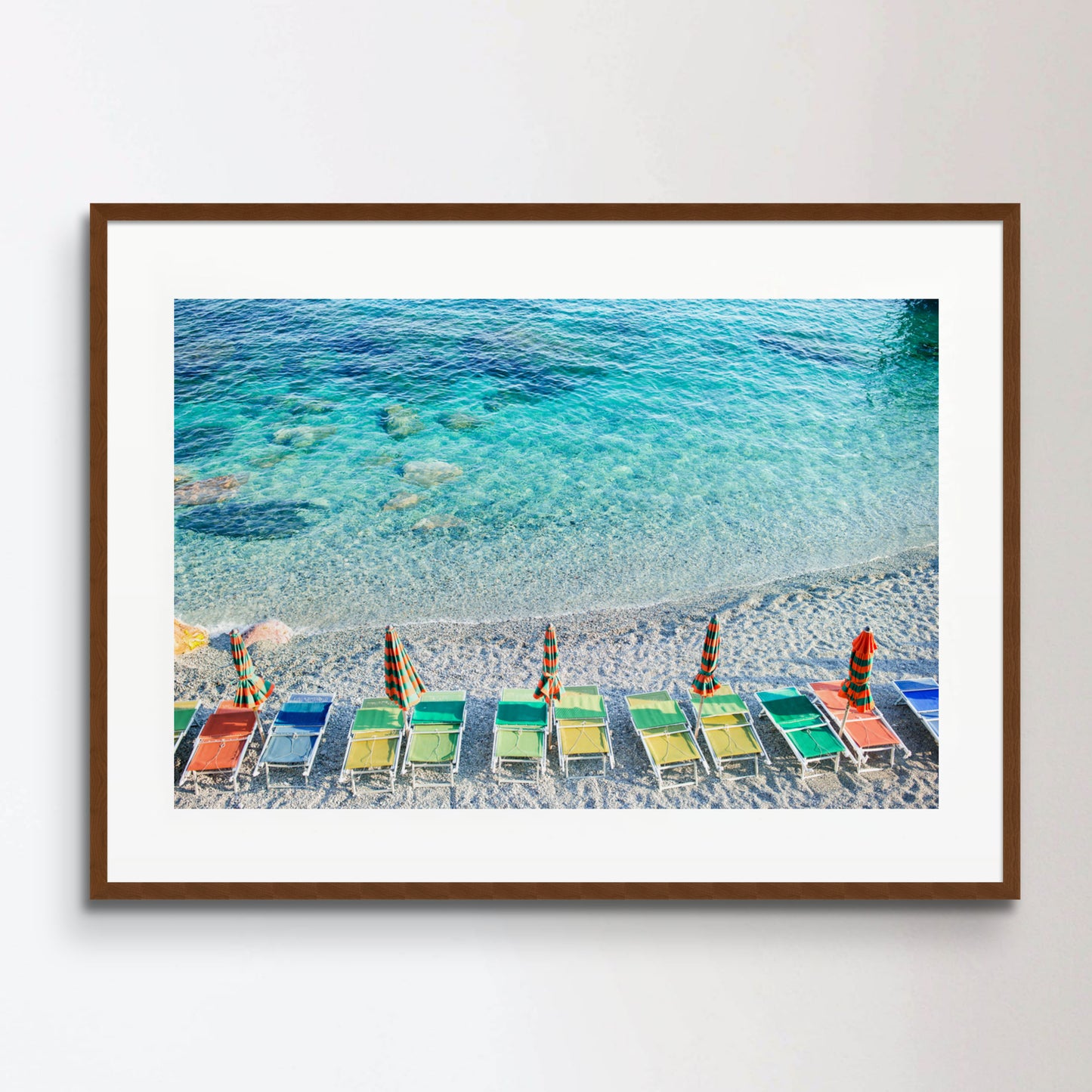 Empty beach with closed umbrellas on italian coast