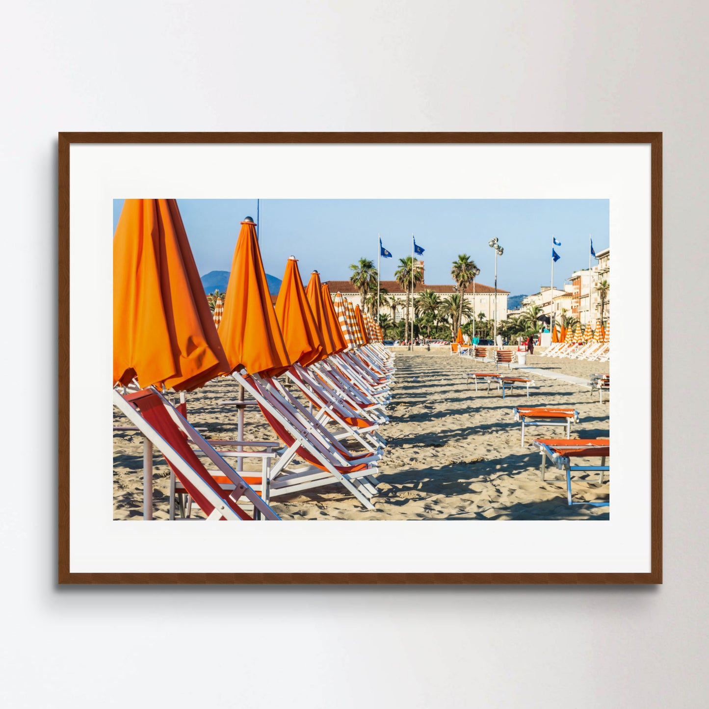 Viareggio beach with colorful umbrellas at sunset, Viareggio, Italy.