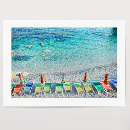 Empty beach with closed umbrellas on italian coast