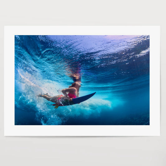 Beautiful surfer girl diving under water with surf board