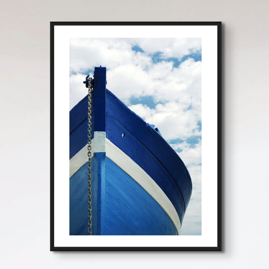 White and blue wooden boat with anchor