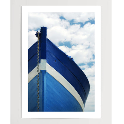 White and blue wooden boat with anchor