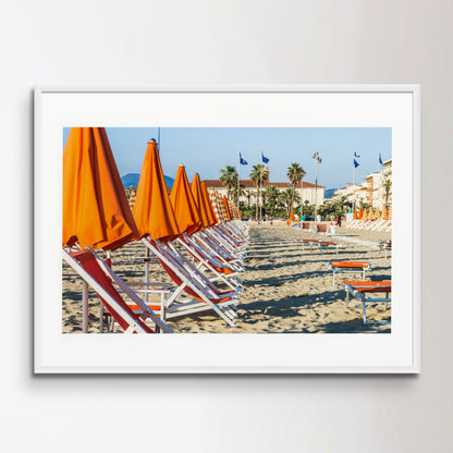 Viareggio beach with colorful umbrellas at sunset, Viareggio, Italy.