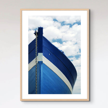 White and blue wooden boat with anchor