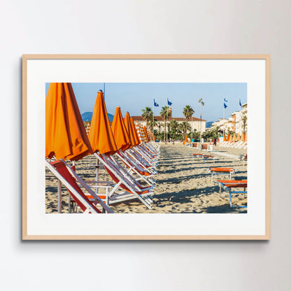 Viareggio beach with colorful umbrellas at sunset, Viareggio, Italy.