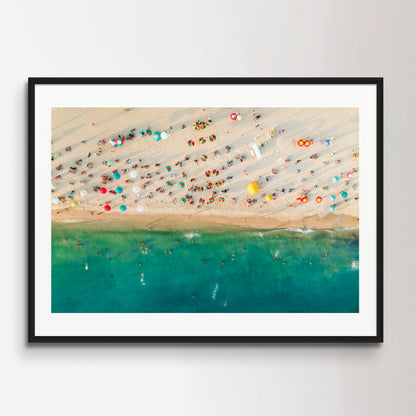 Aerial view of a crowded beach, umbrellas and people on the sand